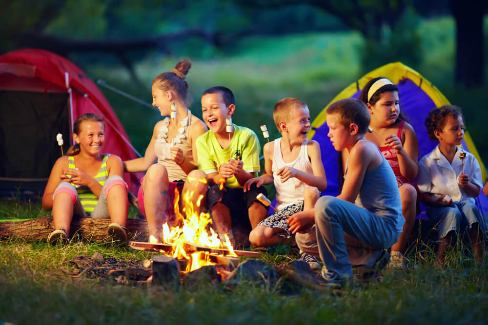 Our Community Involvement – children around a campfire